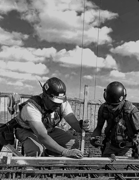 Construction workers installing steel reinforcement bars for concrete slab