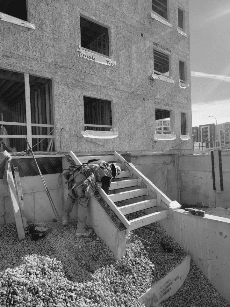 Construction worker installing steel reinforcement bars for concrete foundation